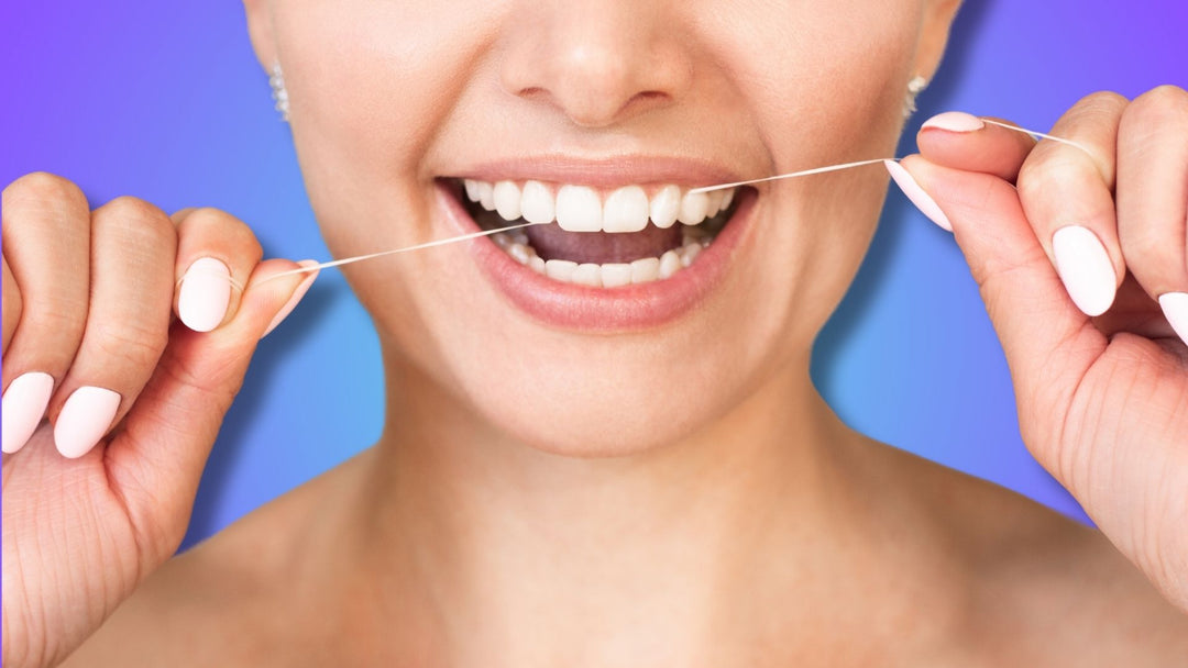 A woman flossing teeth