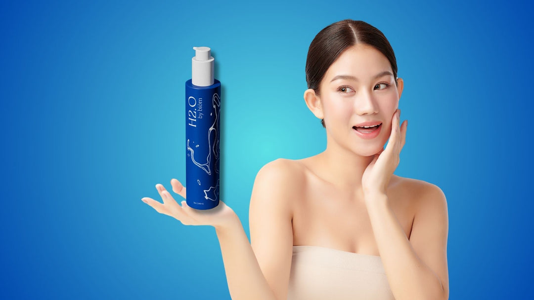 a lady holding a bottle of H2.O Facial Cleanser
