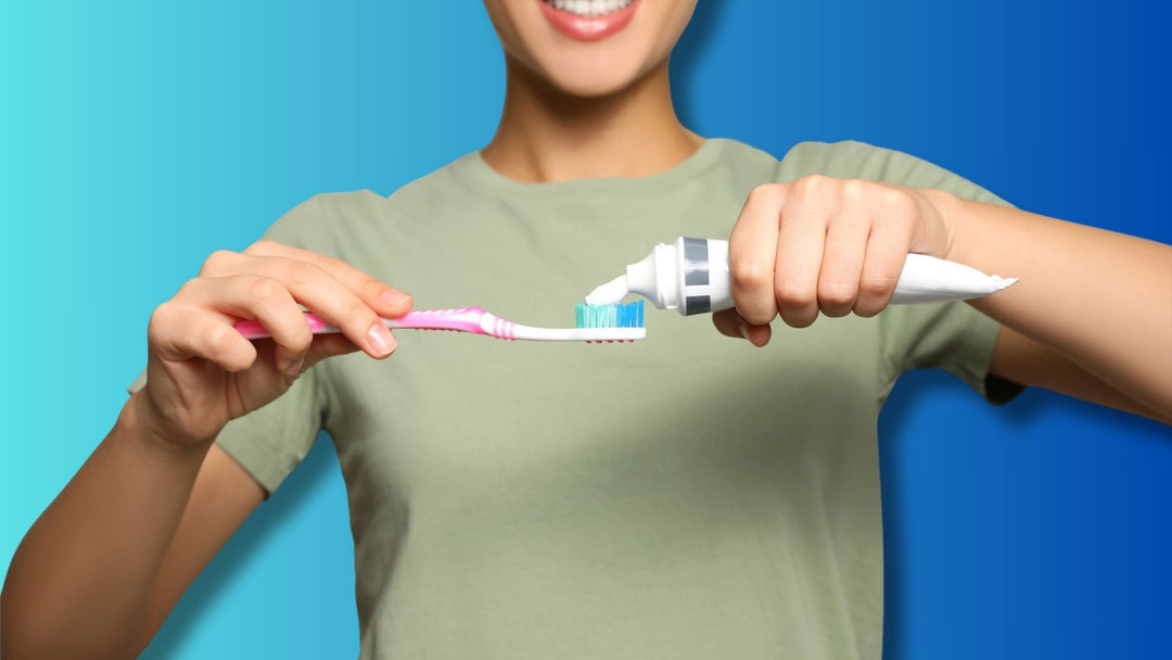 A woman using fluoride toothpaste