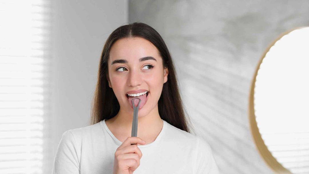 A woman scraping her tongue