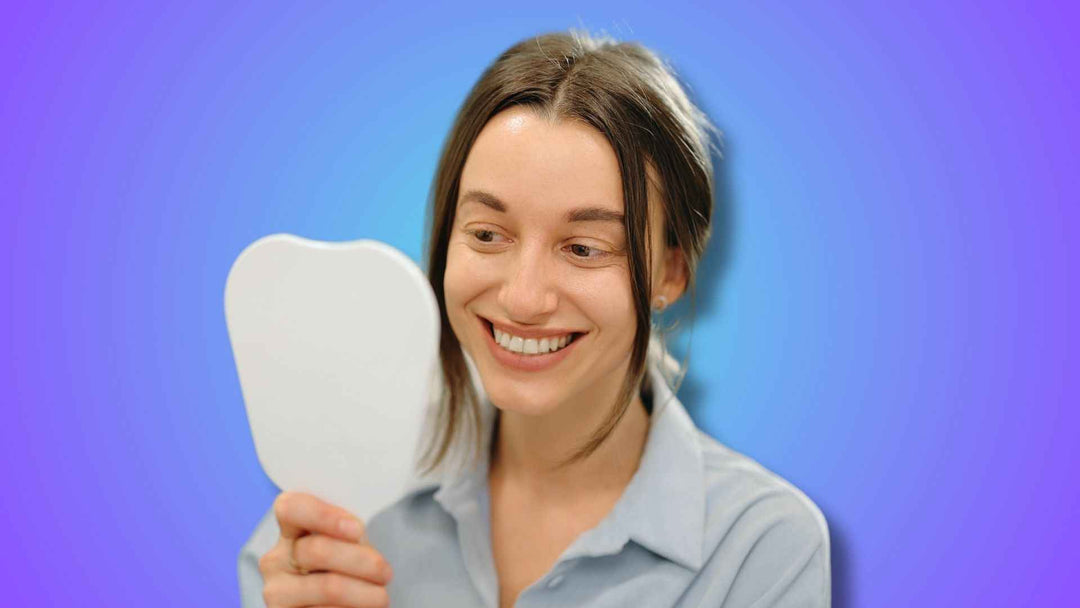 a woman checking her teeth in the mirror