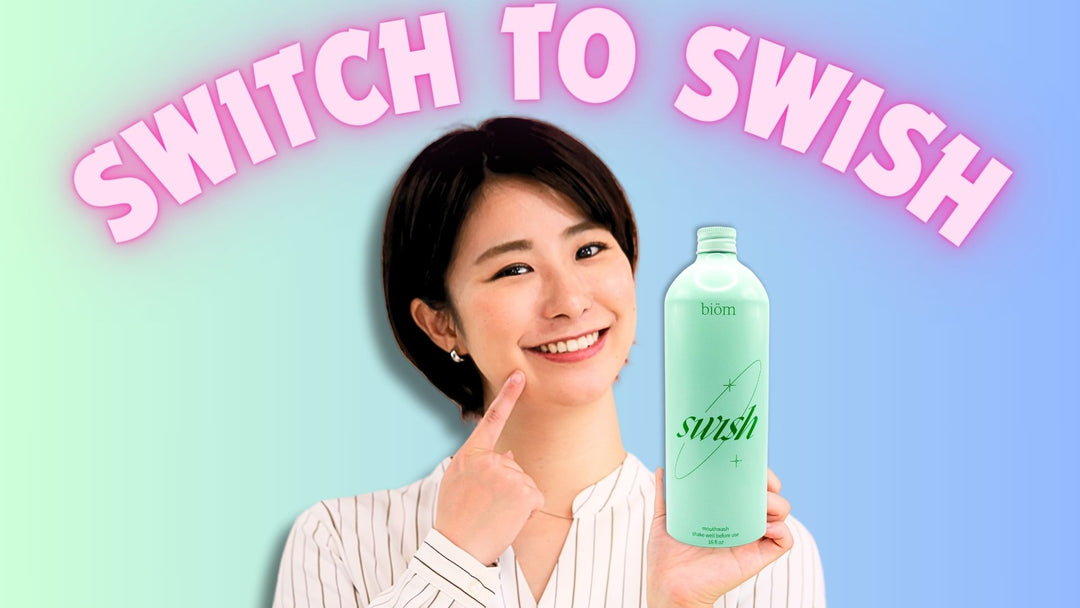 A Woman Holding a Bottle of SWISH Mouthwash
