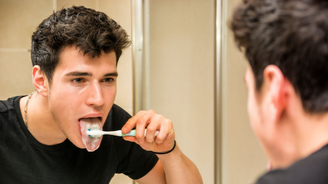 A man brushing his tongue